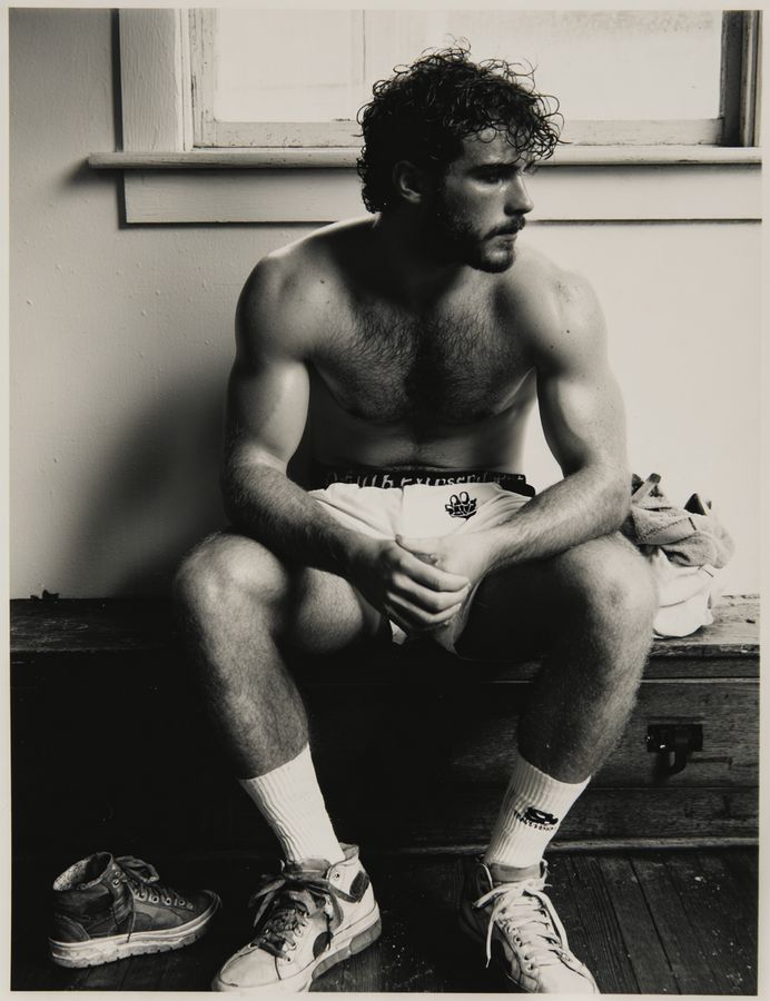 A man sitting on a step with his hands clasped