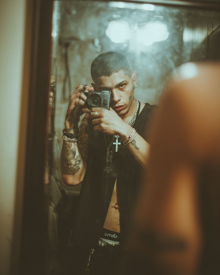 A man photographing himself in a mirror
