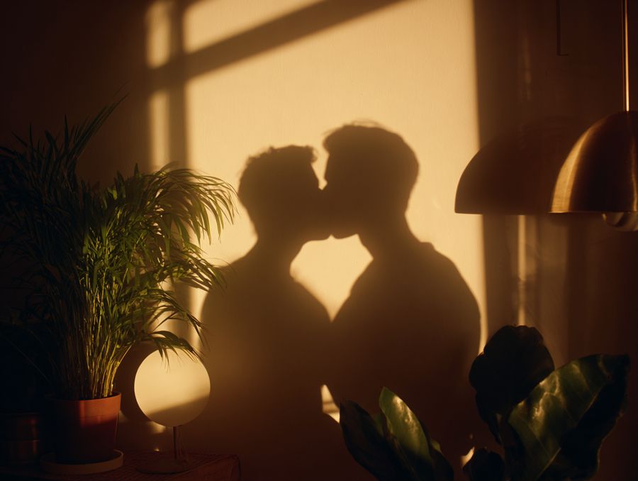 Two figures silhouetted against a sunlit window
