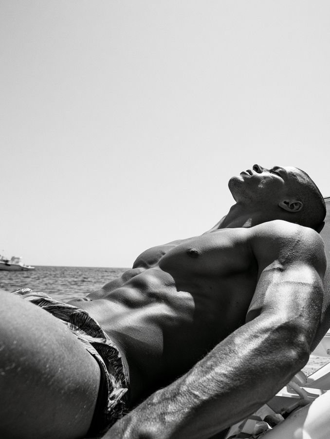 A man lying on a bed, seen from above