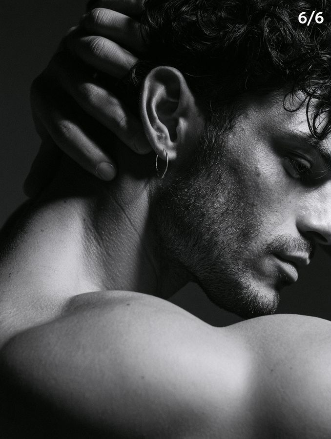 A man resting his head on his arm, in black and white