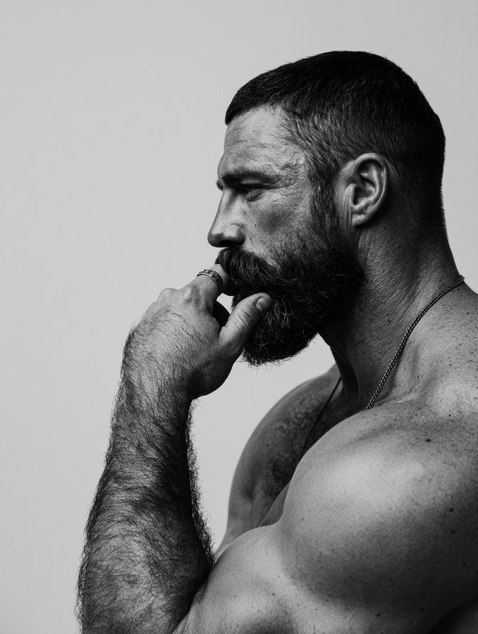 A bearded man in profile, in black and white