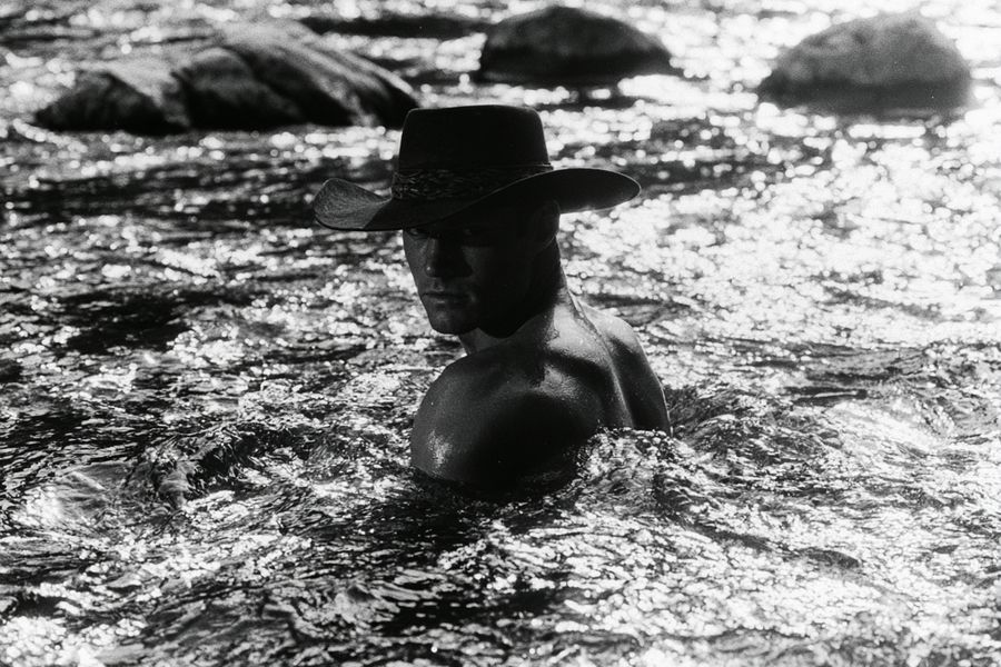 A man bathing in the sea, in black and white