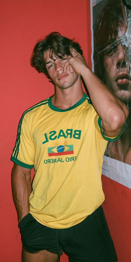 A man in a yellow football shirt against red